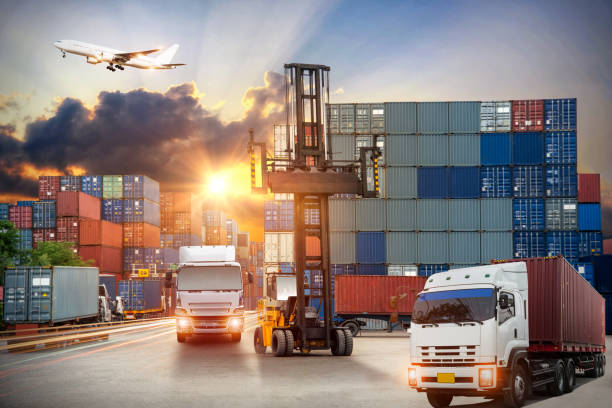 istock forklift handling container box loading to truck in import export logistic, Business logistics concept 883386692