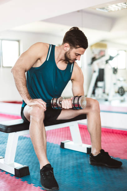 istock fitness man showing the bicep 883421756