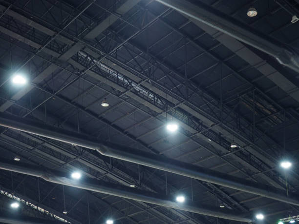 istock High black curve ceiling with steel beam structure and hanging spotlight lamps 883434890