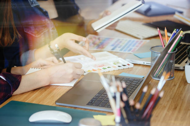 istock Two architects working at a desk and discussing a project. Start up concept. 883526176