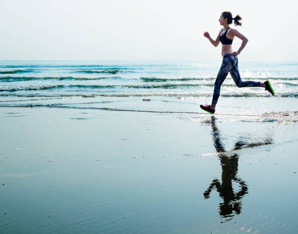 istock A woman is running at the beach 883551888