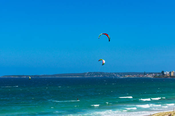istock People kite surfing in the ocean 883561600
