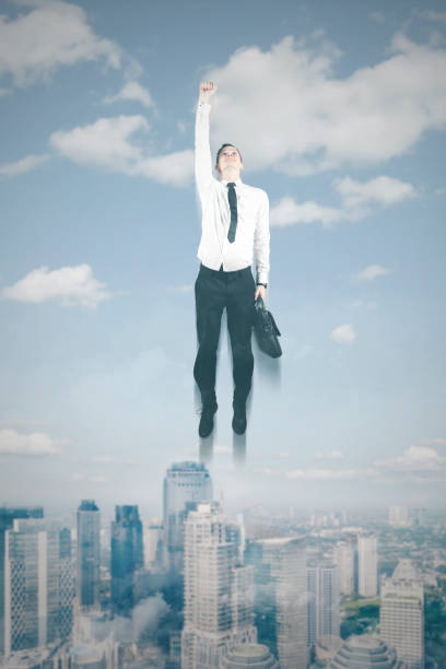 istock European businessman flying in the blue sky 883577954
