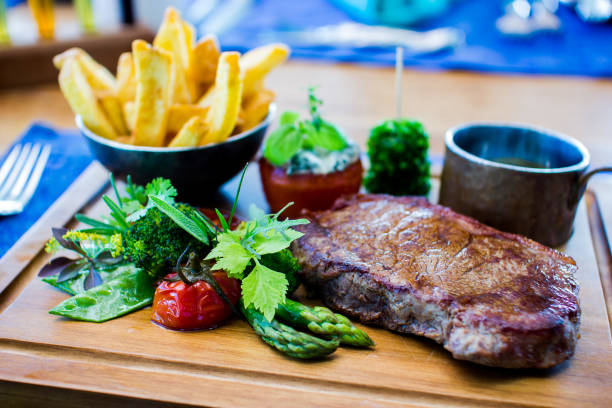 istock Steak and Fries on wood plate 883582012