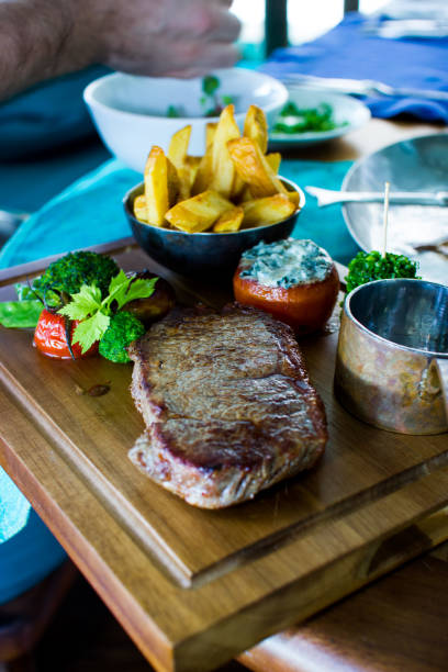 istock Steak and Fries on wood plate 883582022
