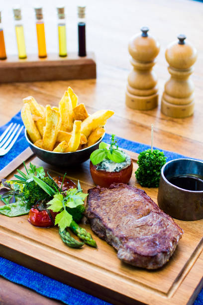 istock Steak and Fries on wood plate 883582052