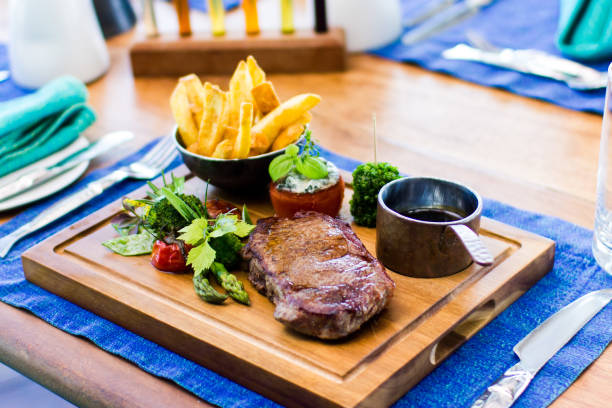 istock Steak and Fries on wood plate 883582066