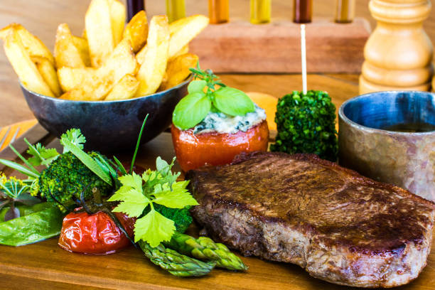 istock Steak and Fries on wood plate 883582128