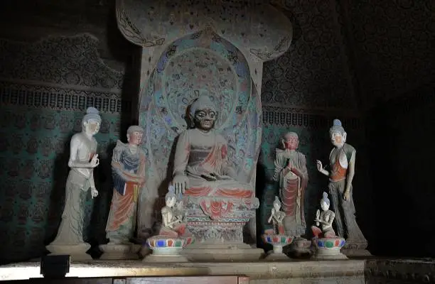 Ancient Buddhist statues at the Mogao Caves, an oasis located at a religious and cultural crossroads on the Silk Road, Dunhuang, Gansu province, China. The caves contain some of the finest examples of Buddhist art spanning a period of 1,000 years.