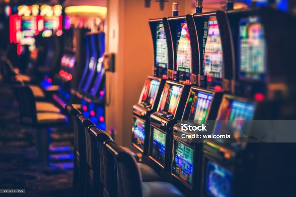 Rows of Casino Slot Machines Rows of Casino Slot Machines with Shallow Depth of Field. Las Vegas Gambling Theme. Casino Stock Photo