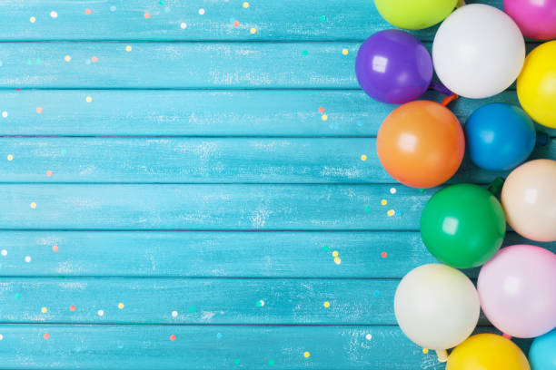 Balloons and confetti border. Birthday or party background. Festive greeting card. Balloons and confetti border. Birthday or party background. Festive greeting card on vintage shabby table. carnival celebration event photos stock pictures, royalty-free photos & images