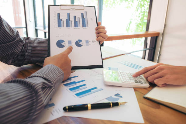 istock Business team meeting working with new startup project, discussion and analysis data the charts and graphs. Digital tablet calculator, laptop computer using, Business finances and accounting concept 883630316