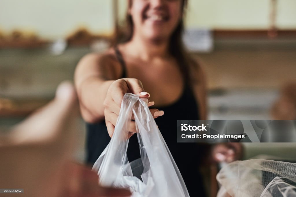 Hope you enjoy! Cropped shot of a young woman working in her bakery Plastic Bag Stock Photo