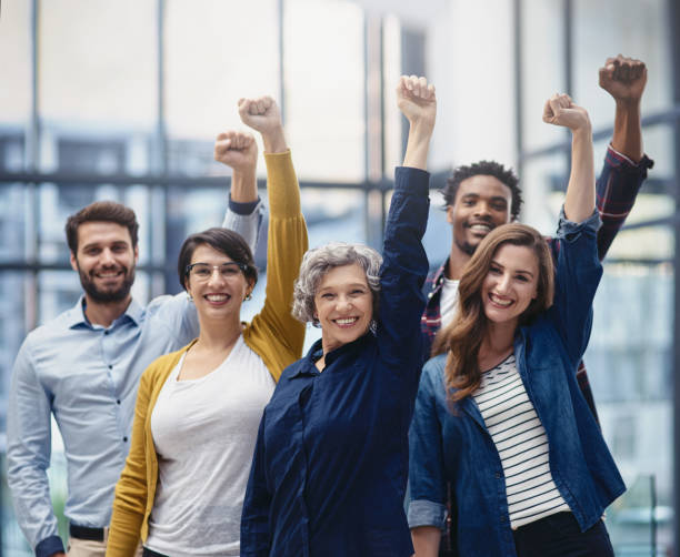 success deserves to be celebrated - women standing fist success imagens e fotografias de stock