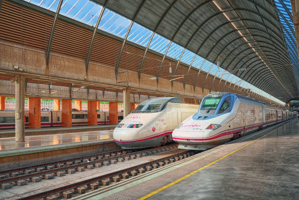 Modern hi-speed passenger train of Spanish railways company-Renfe, on Seville railways station Sevilla Santa Justa. Seville, Spain - June 08, 2017 : Modern hi-speed passenger train of Spanish railways company-Renfe, on Seville railways station Sevilla Santa Justa. seville port stock pictures, royalty-free photos & images