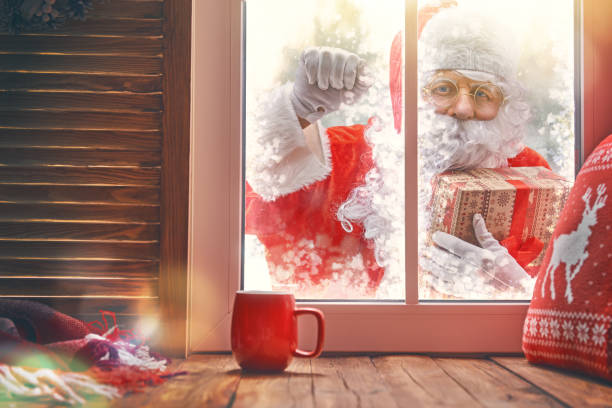 istock Santa Claus is knocking at window 883650856