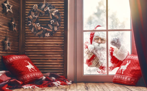 istock Santa Claus is knocking at window 883650866