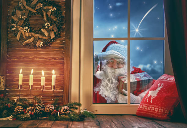 istock Santa Claus is knocking at window 883651008