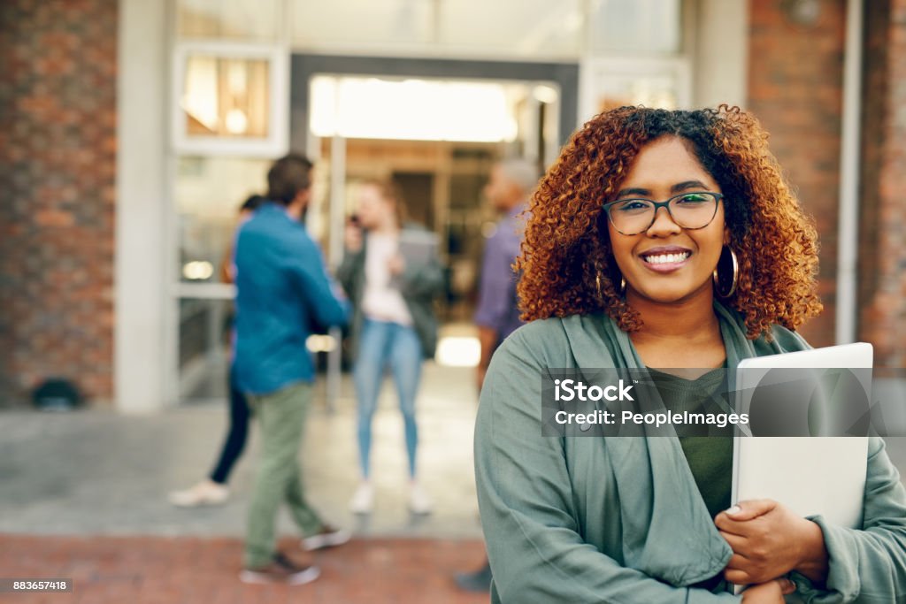 Can't wait to get the semester started Portrait of a happy young woman holding a laptop outdoors on campus University Student Stock Photo