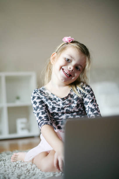 istock Preschool girl using laptop. 883664812
