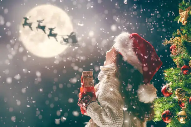 Photo of kid with gift on dark background