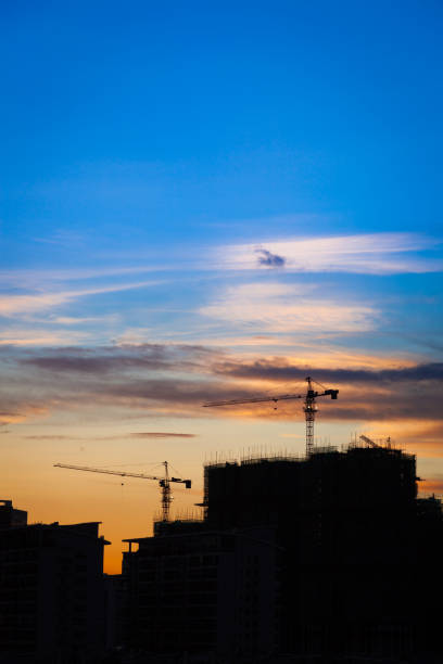 istock Silhouette of city construction Site at sunset 883669380