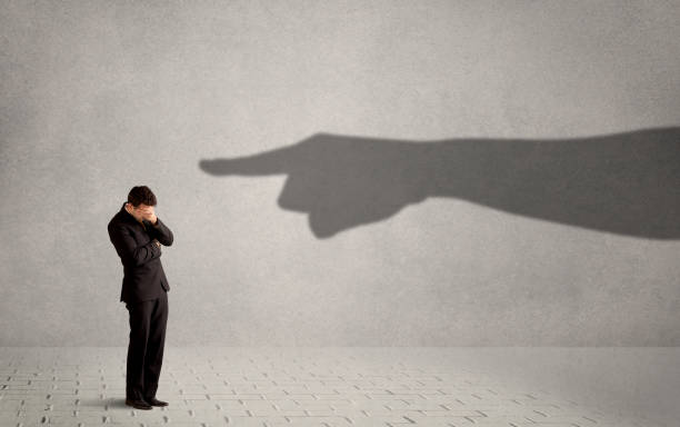 istock Business person looking at huge shadow hand pointing at him concept 883676552
