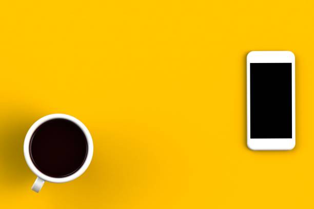 istock Coffee cup with smart phone on yellow background, Top view with copyspace for your text, 3D rendering 883678968
