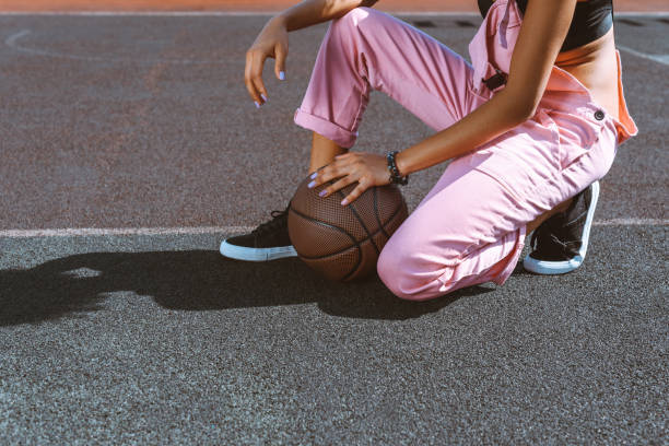 istock woman with basketball ball 883679320