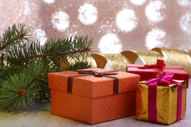 istock Christmas decoration with gift boxes and christmas tree on a blurry, sparkling and fabulous background. 883684216