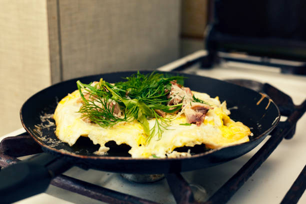 istock Healthy breakfast. Omelette with bacon and arugula fried in a frying pan 883684248