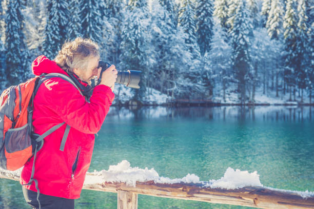 Senior man in the mountains in Winter. Alps, Europe. All logos removed. Nikon.