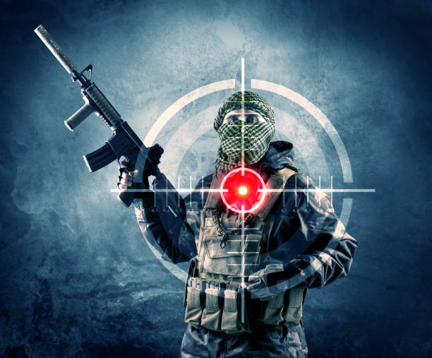istock Masked terrorist man with gun and laser target on his body 883687126