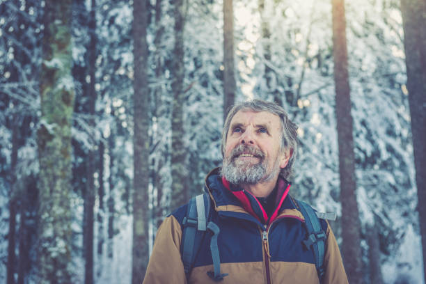 istock Senior Mountaineer in Alps, Winter Forest 883687396
