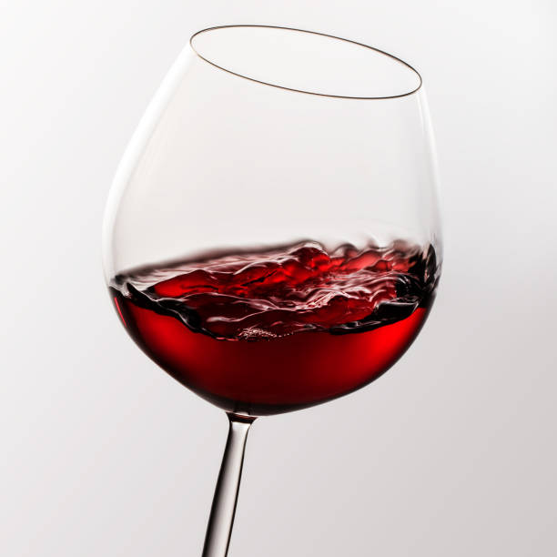 istock Red wine in glass with motion effect. 883695032