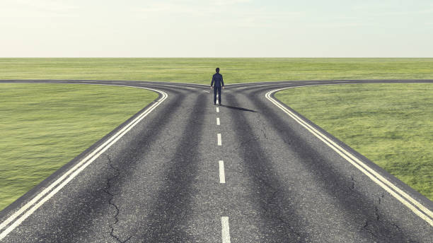 businessman in front of a bifurcation - which path? - decisions nature road street imagens e fotografias de stock