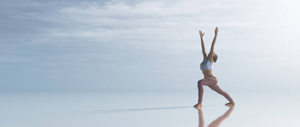 istock Young woman doing yoga outdoo 883695224