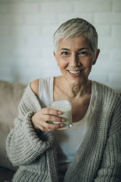 happy senior woman with yogurt mustache at home. - milk mustache imagens e fotografias de stock