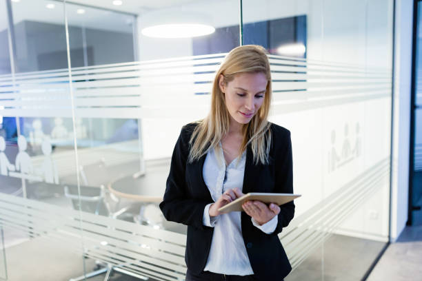 istock Beautiful businesswoman using digital tablet in office 883698090
