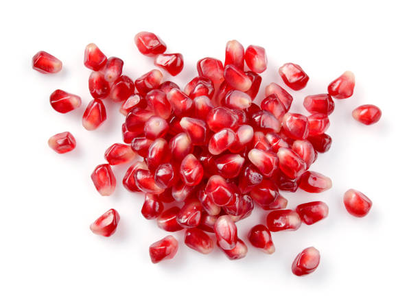 istock Pomegranate. Pomegranate seeds isolated on white. 883702968