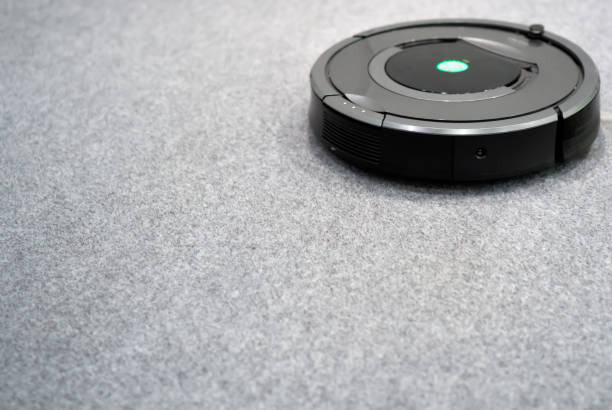 istock Robotic vacuum cleaner. Place for text. 883703150