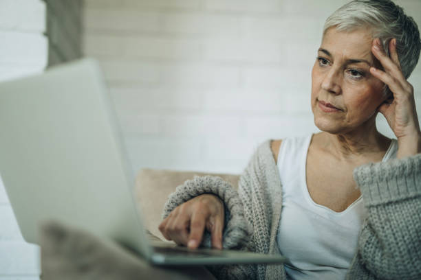 istock Worried senior woman reading an e-mail on laptop. 883703428