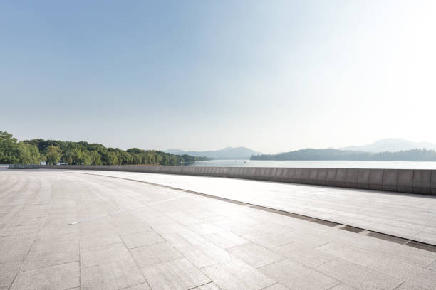 istock empty marble floor with beautiful lake in blue sky 883714226