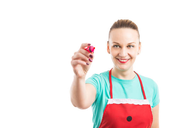 istock Woman wearing red apron writing on invisible screen 883726636