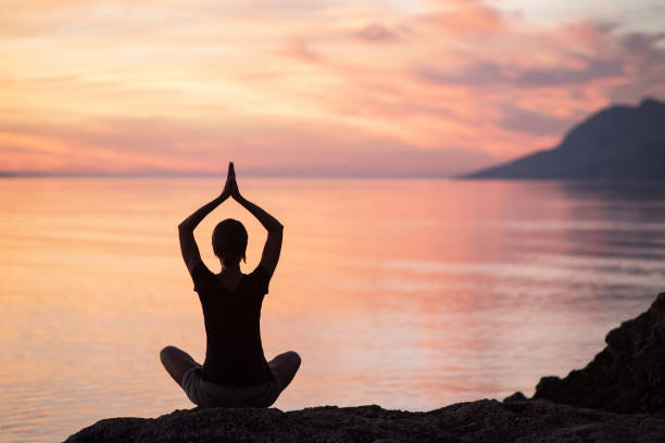 istock Woman is practicing yoga outdoors. Meditation and harmony concept 883726674