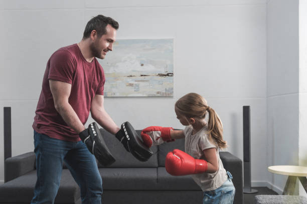 istock preschooler child learning boxing with father 883726700