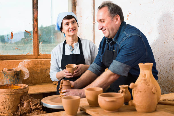 istock Two potters in the process of work at the workshop 883727016