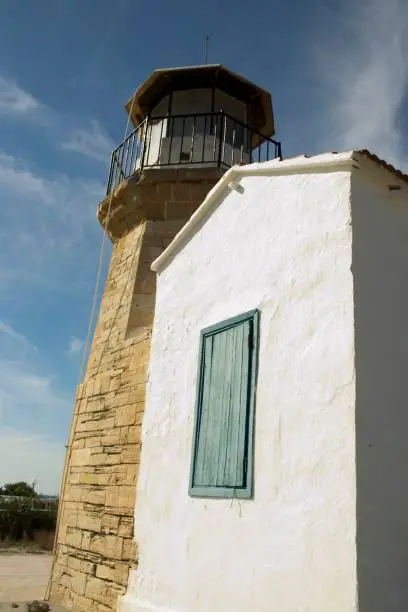 Details of outdoor architecture of a old lighthouse from Cyprus and cloudy blue sky