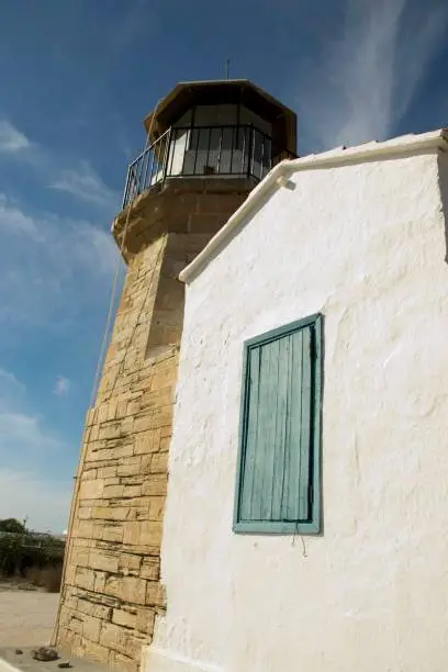 Details of outdoor architecture of a old lighthouse from Cyprus and cloudy blue sky