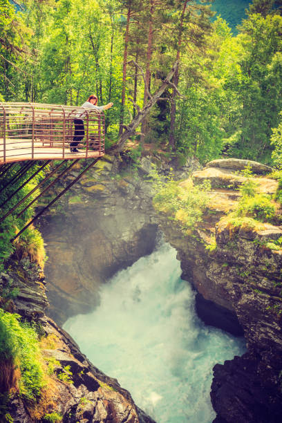 istock Tourist with camera on Gudbrandsjuvet waterfall, Norway 883730410